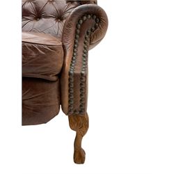 Georgian style wing back reclining armchair, upholstered in buttoned and studded antique brown leather

