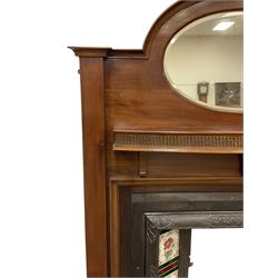 Early to mid-20th century mahogany fire surround, stepped arched top with oval bevelled mirror, fitted with shelf with fluted frieze, together with an early to mid-20th century metal fire inset with tiled uprights