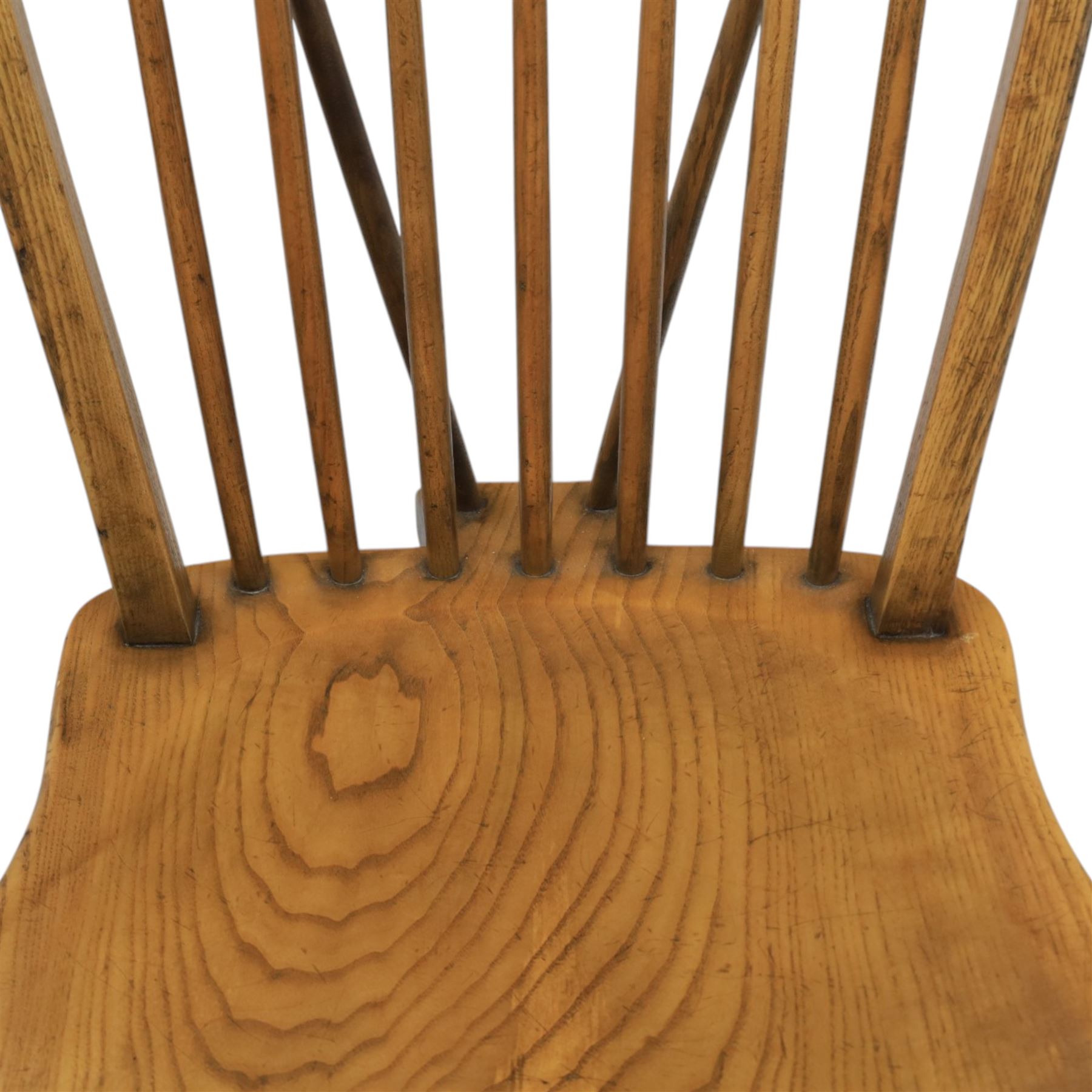 Traditional elm and beech Windsor dining chairs, each with hoop back and turned spindles over a shaped solid seat fitted with loose floral upholstered cushions, raised on turned tapering supports united by crinoline stretchers