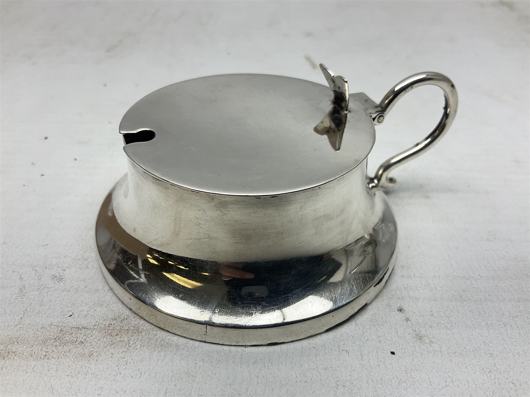 Early 20th century silver mustard pot and cover, with blue glass liner, hallmarked Hawksworth, Eyre & Co Ltd, Sheffield 1911, approximate silver weight 59.4 grams