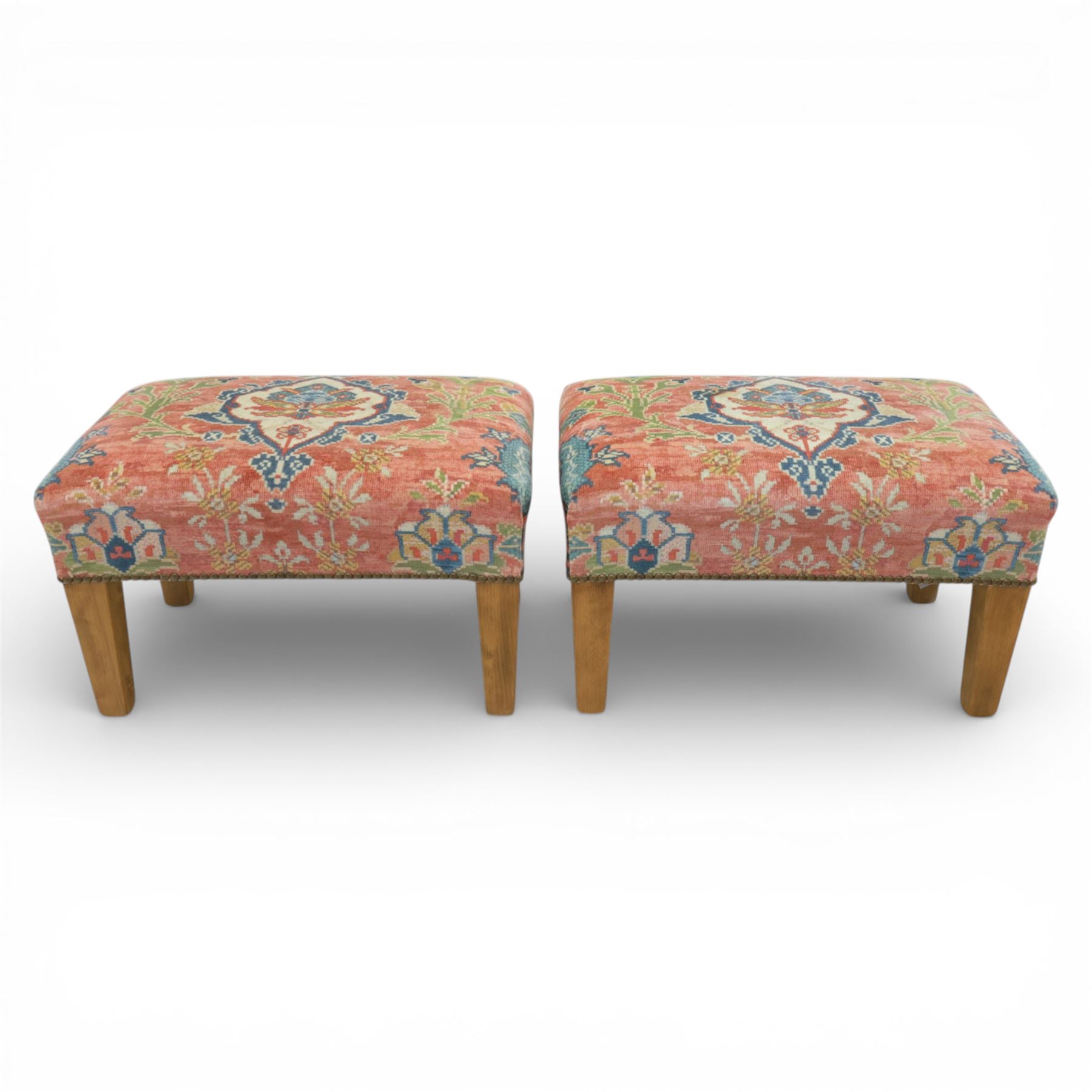 Pair of needlepoint footstools, retailed by The Bespoke Footstool Co, brass studded trim on tapered oak supports