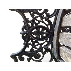 Victorian Andrew McLaren pattern cast iron bench, the ornate ends with detailed scrollwork, joined together with a cast iron seat and backrest frame supporting gently weathered oak slats, Victorian diamond stamp mark