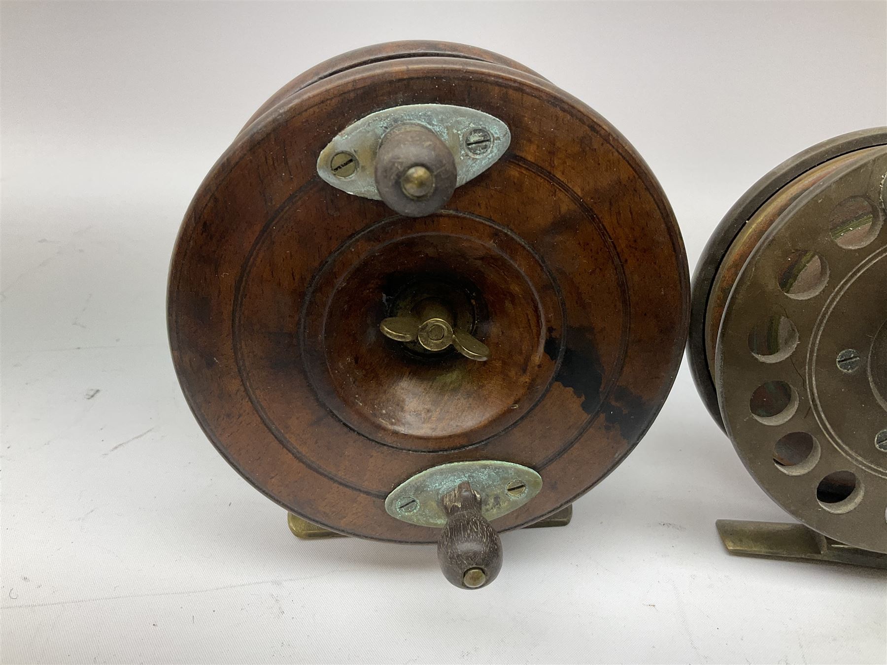 Three Allcocks & Co Ltd reels of brass and wood construction, the largest D4.5 inches