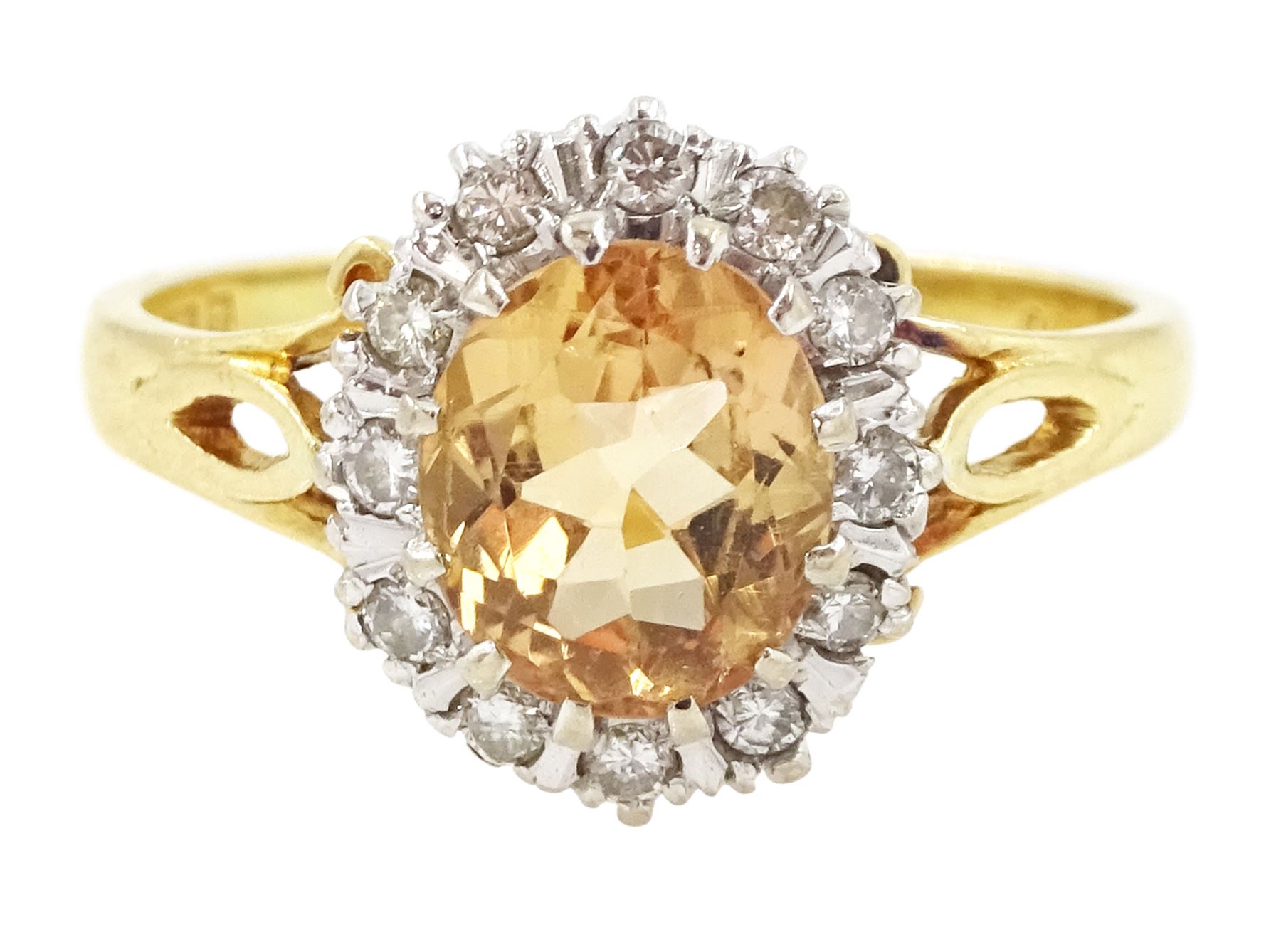 18ct gold imperial topaz and diamond cluster ring, oval cut topaz of approx 1.50 carat, surrounded by twelve round brilliant cut diamonds, London 1987, total diamond weight approx 0.10 carat