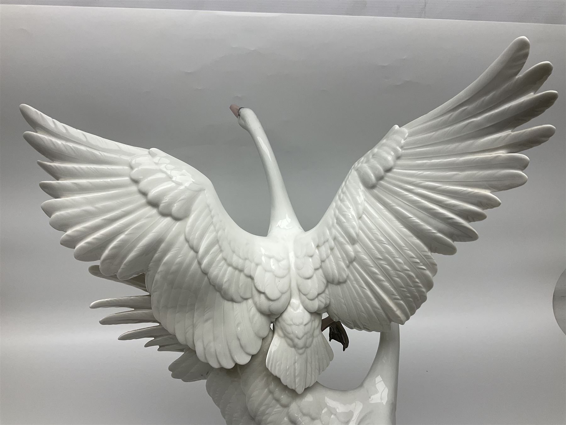 Large Lladro figure group, Swans Take Flight, modelled as two swans upon raised on circular wooden plinth, sculpted by Salvador Debon, H68cm