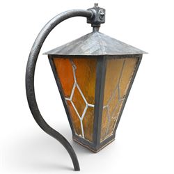 REVO Electric Co. Ltd., Tipton - early 20th century cast iron street lamp standard, the later hexagonal lantern with amber leaded glazing and pointed finial, supported on a swan-neck bracket above a ring-turned capital, tapering column and ladder rest, terminating in a moulded scrolling foliate-decorated base with lappet collar, stamped REVO

Provenance: formerly installed as street lighting in Prestwich, Greater Manchester
