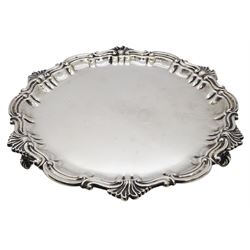 Edwardian silver waiter, of circular form with cast shell and C scroll rim, upon three scroll feet, hallmarked Thomas Bradbury & Sons, London 1902, D21.5cm, approximate weight 10.66 ozt (331.8 grams)
