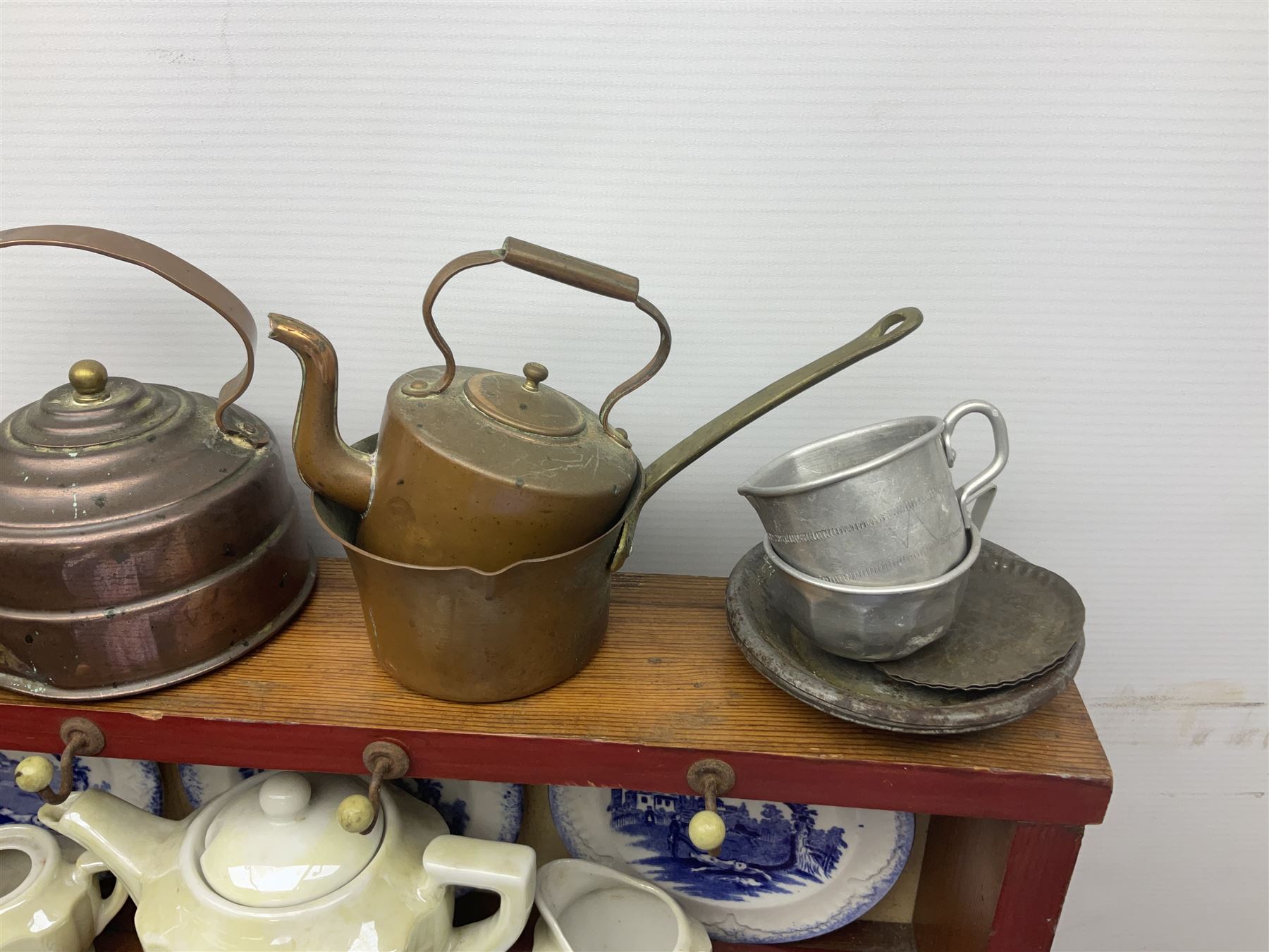 Miniature pitch pine Welsh dresser with open plate rack over two cupboard doors, displayed with Ridgways Humphrey's Clock pattern and other doll's blue/white tea ware, copper kettles and pan etc W41cm H72cm