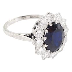 18ct white gold sapphire and diamond cluster ring, single oval cut sapphire of approx 4.50 carat, surrounded by twelve brilliant cut diamonds, Birmingham 1982, total diamond weight approx 2.65 carat