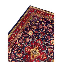 Persian Sarouk rug, blue ground with central floral medallion, decorated all-over with interlacing branch and flower head motifs 