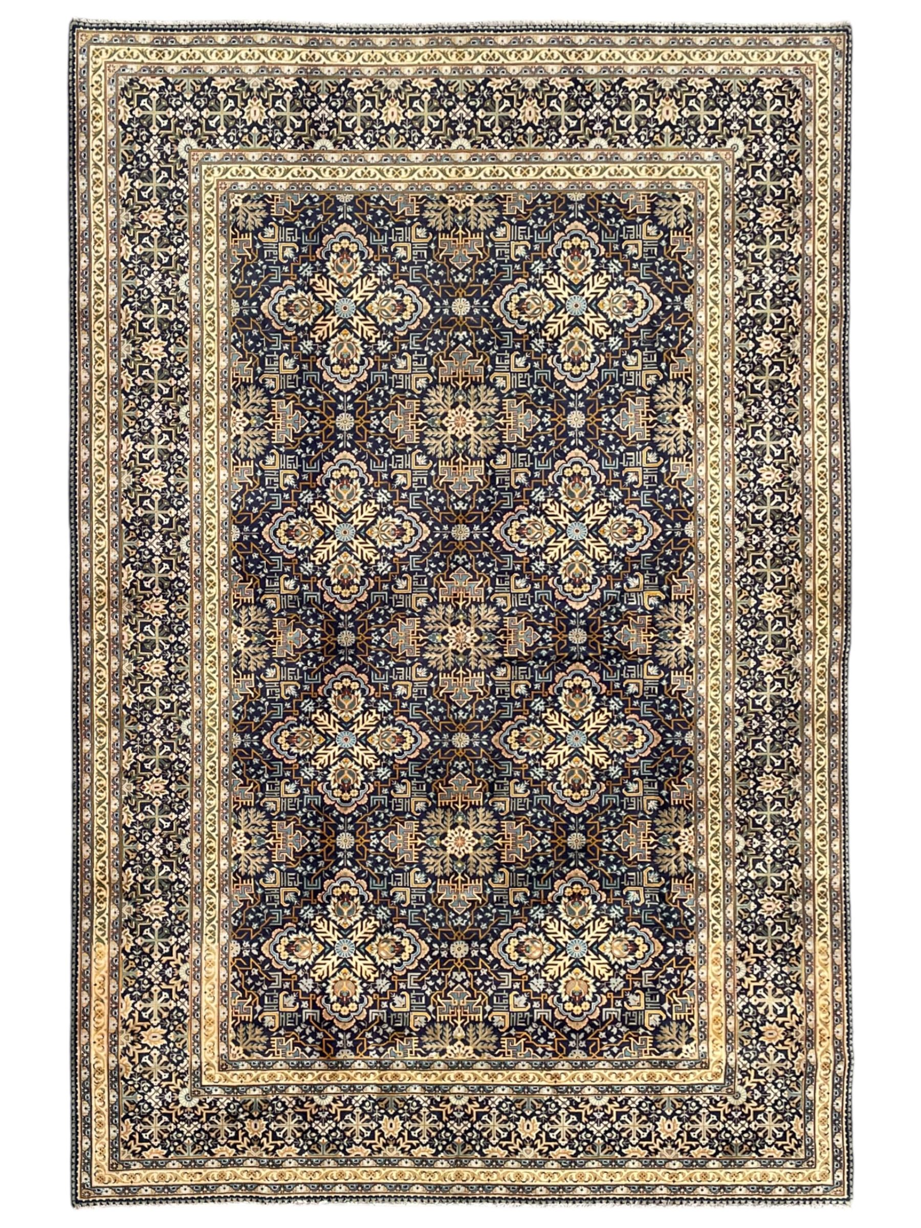 Persian indigo and pale gold ground rug, overall busy geometric design, the field decorated with hooked Hac and palmette medallions surrounded by densely patterned zig-zags and stylised foliate motifs, the border decorated with smaller Hac motifs, within multiple guard stripes 
