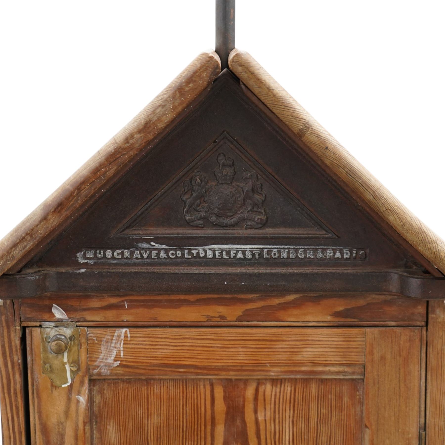 Musgrave & Co Ltd (Belfast) - late 19th century pine saddle horse, with three drawers to one end and cupboard door to the other, the hinged top opening to form a table, the cast iron plaque bears the Royal coat of arms and maker's name