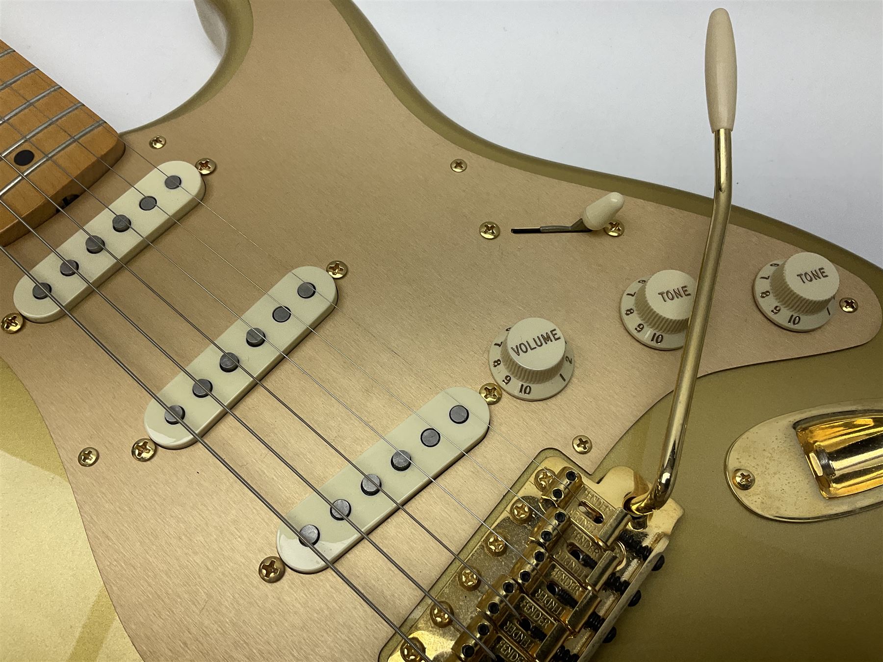 Fender Stratocaster 50th Anniversary 2004 metallic gold electric guitar; serial no.MZ4116369; L98cm; in Spider fitted case with owners manual and other paperwork, strap and belt buckle etc