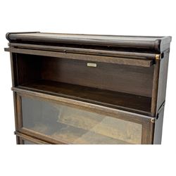 Globe Wernicke - stacking sectional library bookcase, over four glazed up-and-over doors, each bearing original makers mark, on moulded plinth base with inbuilt drawer
