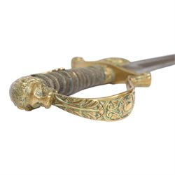 WWI Prussian Artillery Officer's dress sword, with 83cm single edge fullered steel blade, brass stirrup hilt, the langet with crossed cannon barrels and a vacant shield cartouche, the curved knuckle bow cast with acorns and oak leaves, wire bound grip and lion head pommel, with steel scabbard, overall L100cm