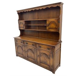 Traditional oak dresser, raised plate rack fitted with two cupboard, the dresser with moulded rectangular top over three drawers and three cupboards, stepped arch panelled doors