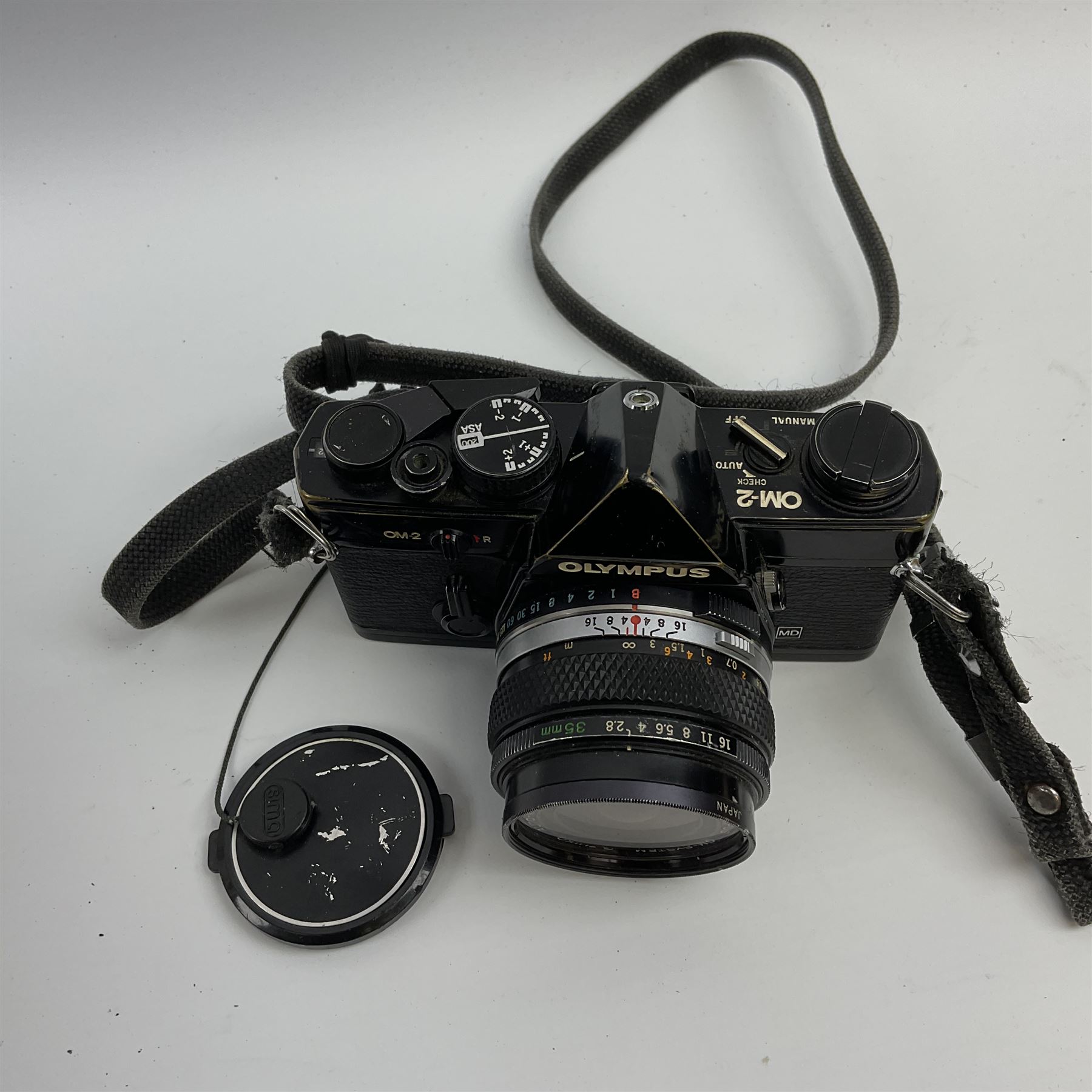 Olympus OM2 camera, 'no.264258', fitted with Olympus 'OM System G.Zuiko Auto-W 1:2.8 f35mm' lens and two other lenses, in a carry case