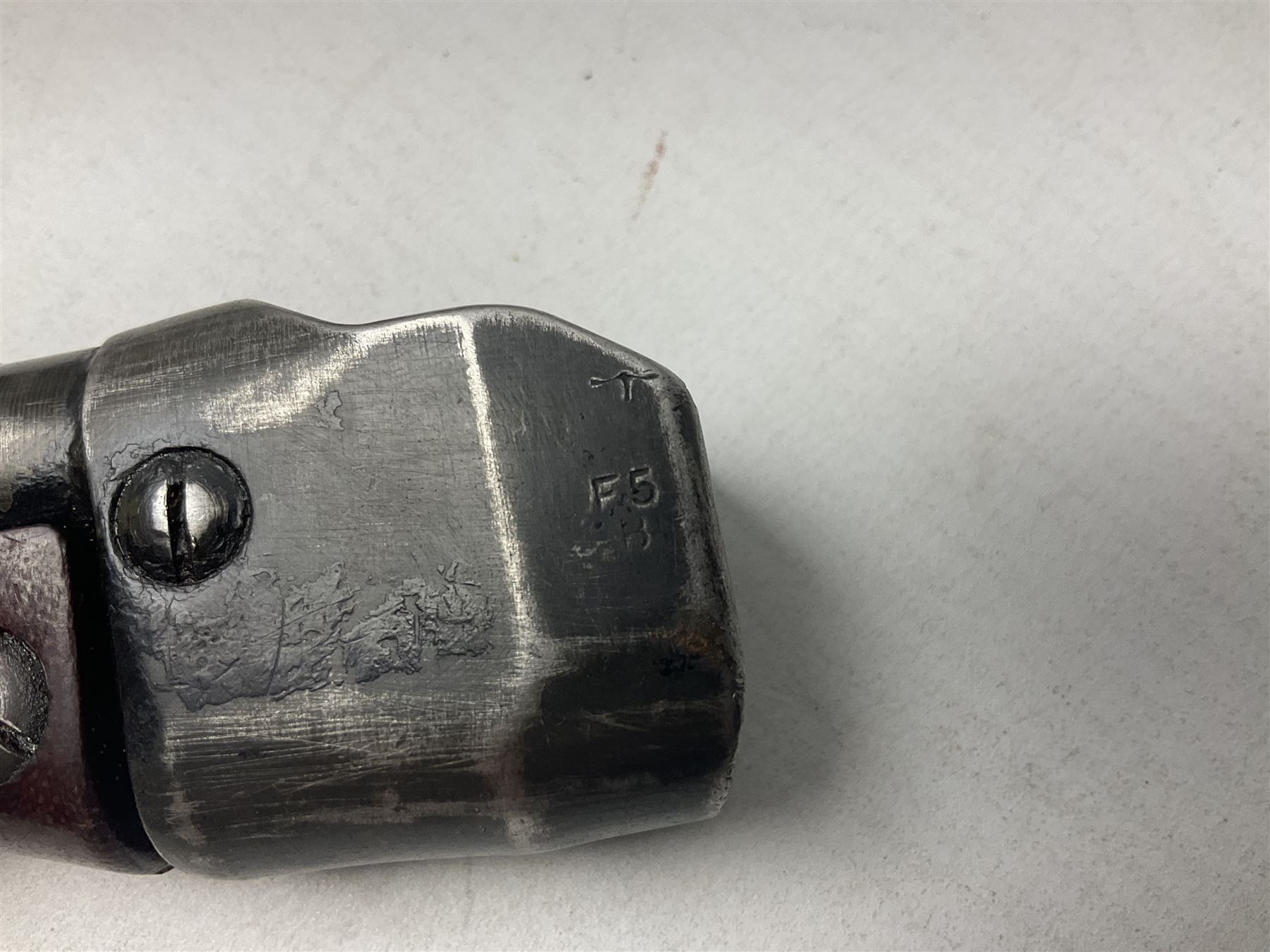 British No 7 MKI knife bayonet with 20cm single edged fullered clipped point blade;  blackened steel, large muzzle ring cross-guard; blackened swivelling pommel marked 'F5H'; red Tufnol composite grips; in blackened steel scabbard L33cm overall; British Pattern 1888 bayonet with scabbard; and German Ersatz bayonet with scabbard (3)