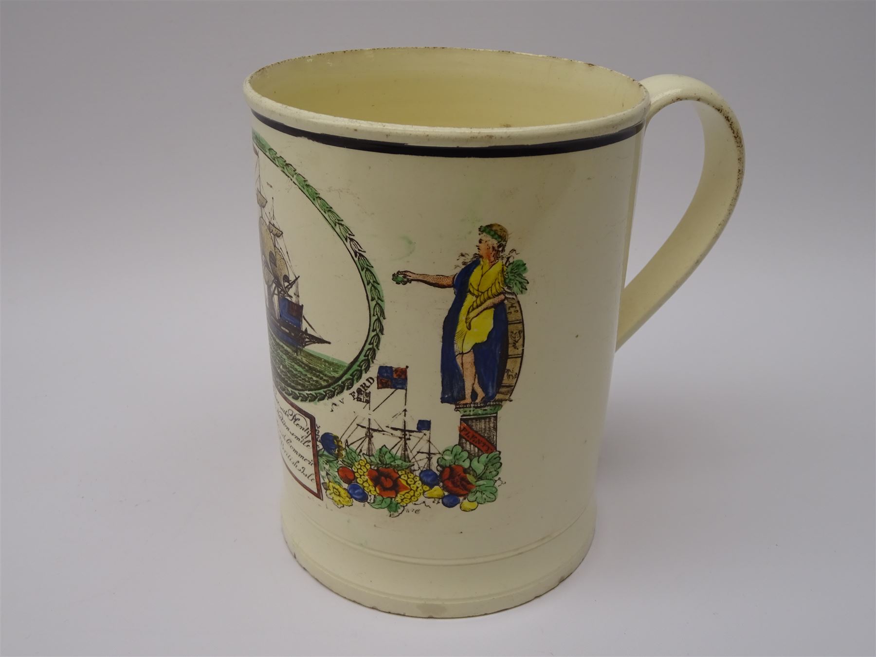 Early 19th century Sunderland Dawson & Co creamware pottery mug, the cylindrical body black transfer printed and polychrome detailed with a circular panel of a three-masted ship flanked by two figures of Peace and Plenty, above a panel containing verse 'May Peace with Plenty on our Nation smile [...]' H15cm D11cm