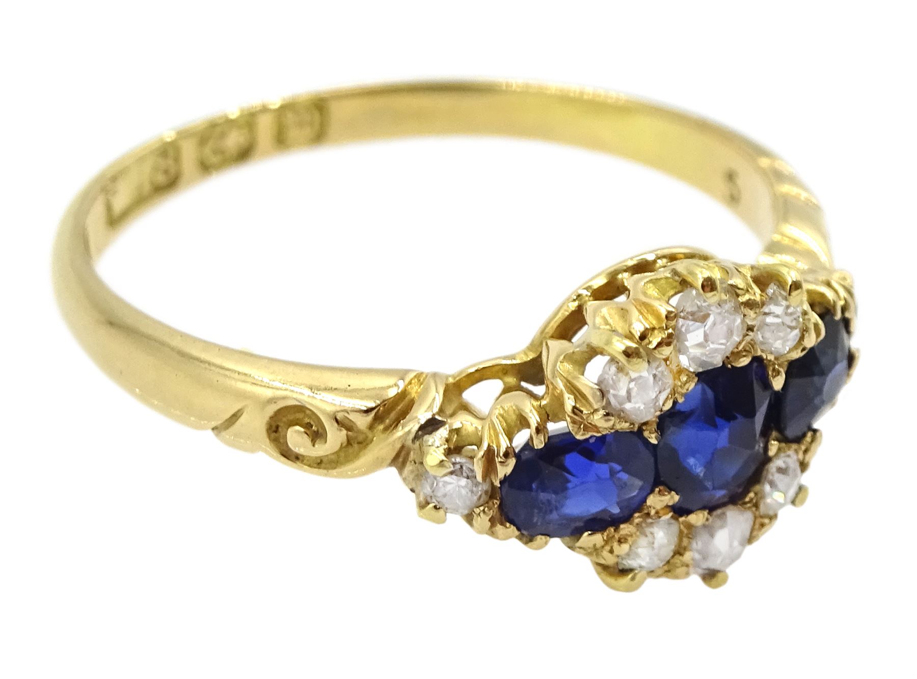 Victorian 18ct gold sapphire and diamond cluster ring, with engraved scroll design shoulders, Birmingham 1896