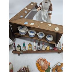 Victorian and later style dolls house kitchen furniture, including countertop, dresser displaying copper pots and blue and white ceramics, baking table, oven, three figures and a collection of food and baking accessories