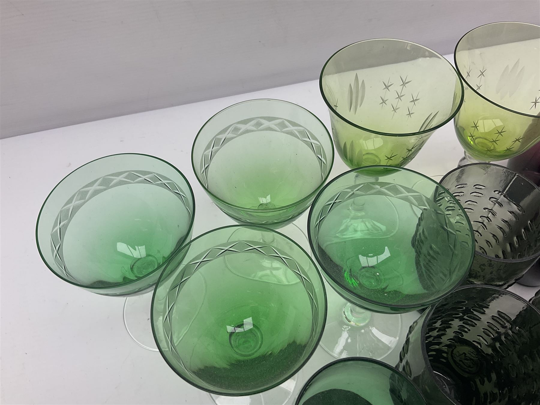 Set of four Swedish Reijmyre drinking glasses, with textured outer surface, together with green drinking glasses including Holmegaard examples and other glassware