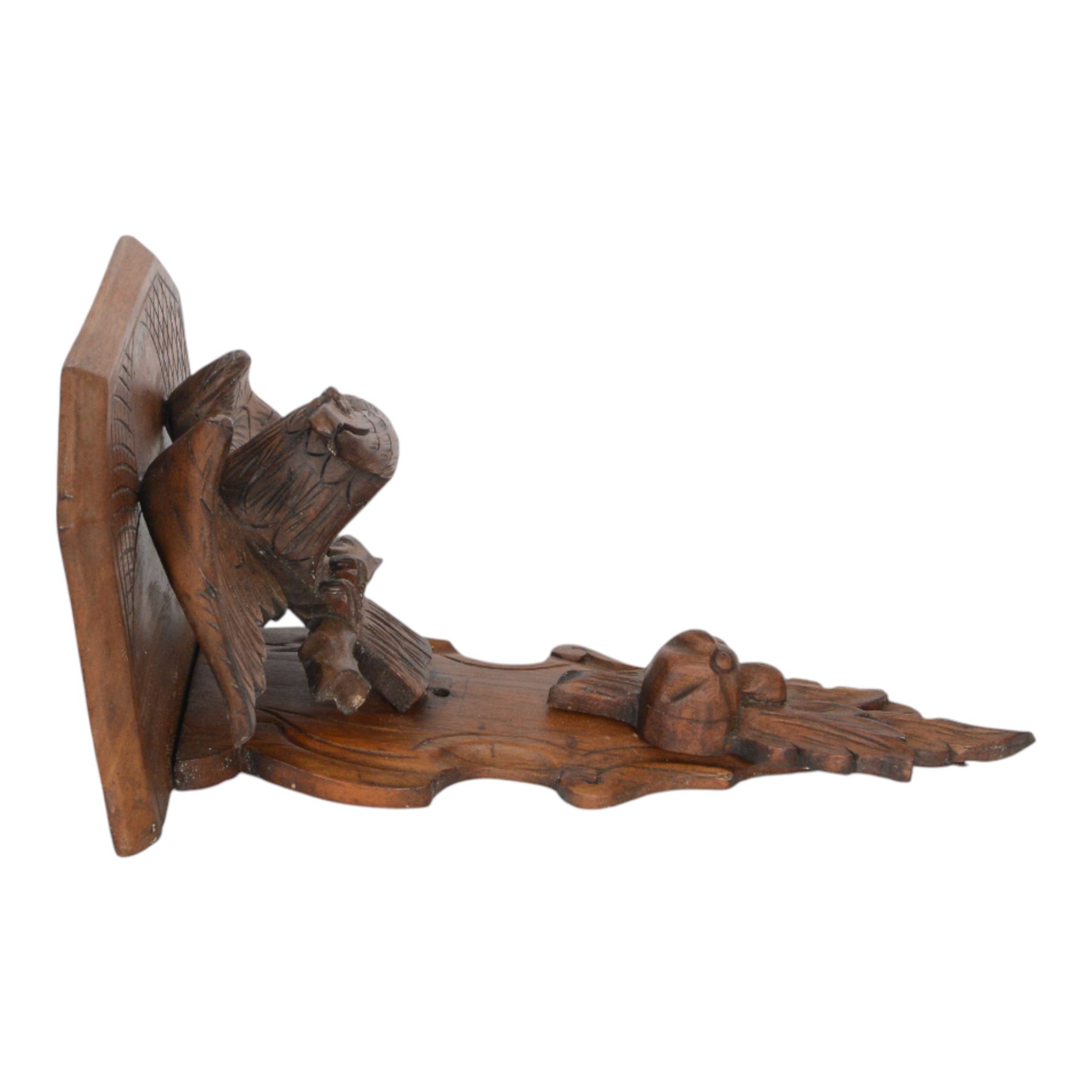 Edwardian oak clock bracket, carved with an eagle support over fruiting foliage, H37cm