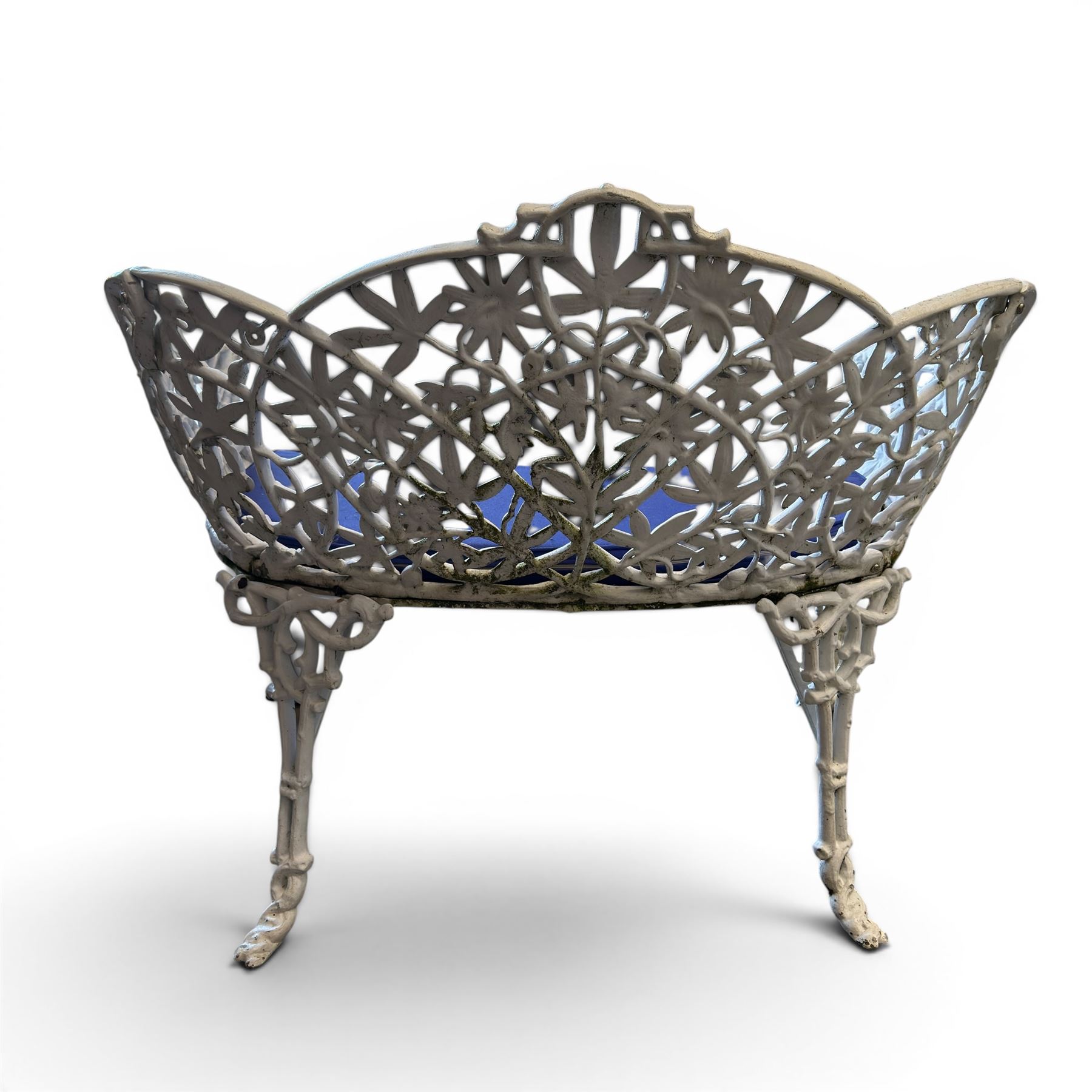 Victorian revival cast two seat garden bench, scrolling lattice back with flower heads, terminating to rams heads arms, curved pierced seat, finished in antique white paint
