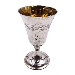 Modern limited edition silver goblet, a replica of the original silver chalice of Lincoln Cathedral, with hand planished decoration, and engraved band of laurel leaves to bowl, with gilt interior, upon waisted stem and circular stepped foot, no. 144/200, hallmarked John Cussell, London 1977, H15cm