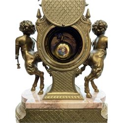 Imperial - 20th century continental 8-day brass and marble mantle clock, with an enamel dial, Roman numerals and pierced gilt hands, twin train striking movement sounding the hours and half hours on two bells, with a floating balance escapement.  With key.