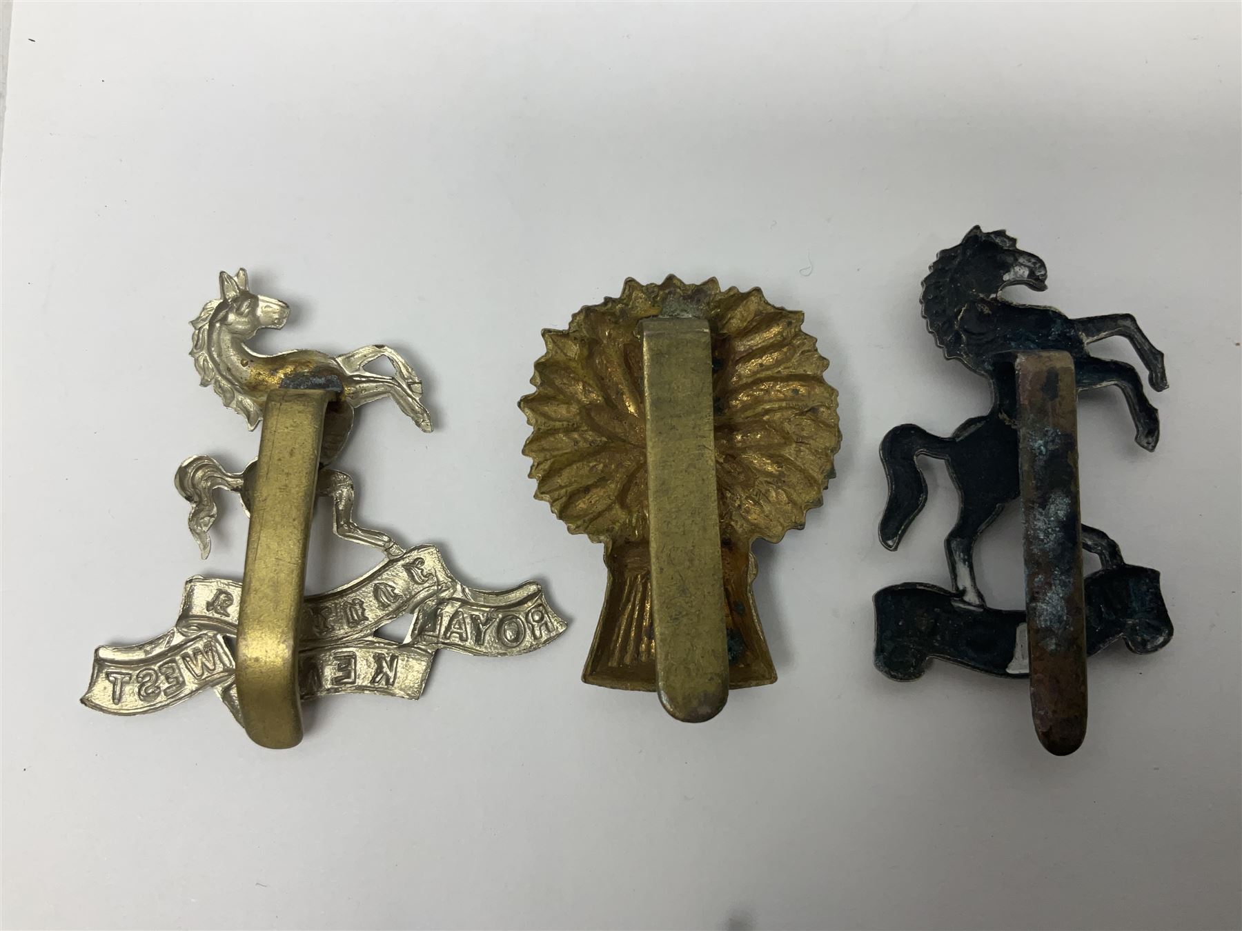 Nineteen Yeomanry metal cap badges including Derbyshire, Northamptonshire, Essex, Glamorgan, Staffordshire, City of London, Surrey, Shropshire, Hertfordshire etc; together with eleven Fusiliers badges including Lancashire, Royal Welch, Northumberland etc (30)