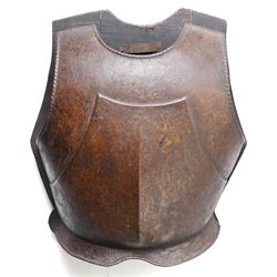 16th century breast plate with ridged front H36cm mounted on a wooden board