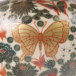 Japanese ceramics table lamp, decorated with flowers and butterflies upon a circular wooden base, H52cm