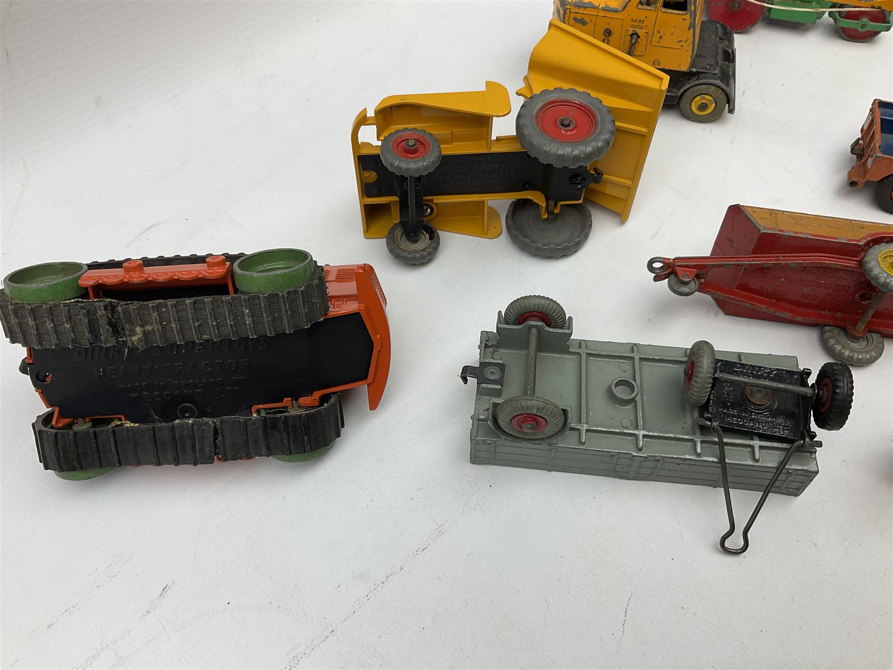 Dinky - nineteen unboxed and playworn/repainted die-cast models including Muir Hill Dumper, Muir Hill 2WL and Heavy Tractor; all repainted; Coles Mobile Crane, two Aveling-Barford steam rollers; Massey-Harris tractor and manure spreader; Land Rover; nine various trailers etc (19)