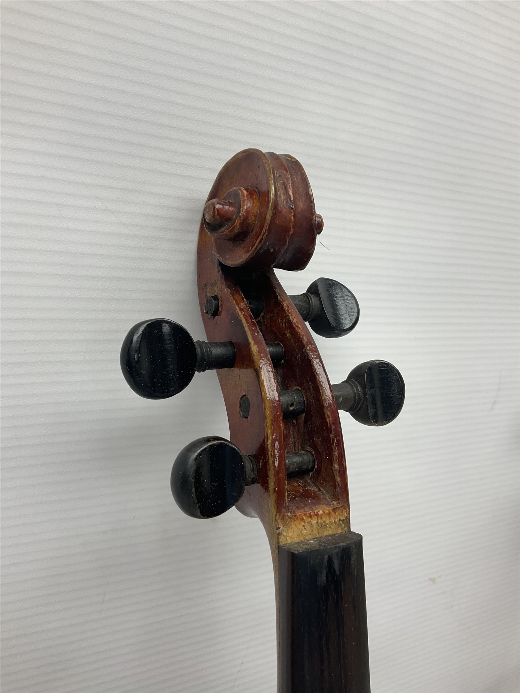 Late 19th century French three-quarter size 'Conservatory' violin with 34cm two-piece maple back and ribs and spruce top, the peg box inscribed 'Conservatory Violin Straduari', bears label 'Antonius Stradiuarius Cremonensis Faciebat Anno 1721' L55.5cm overall; in ebonised wooden 'coffin' case; and Saxony violin c1900 with 36cm two-piece maple back and ribs and spruce top; bears label 'Antonius Stradivarius Cremonensis Faciebat Anno 17**' L59cm overall; in carrying case (2)