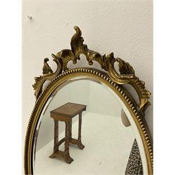 Gilt oval mirror with beading decoration, H65.6cm. 