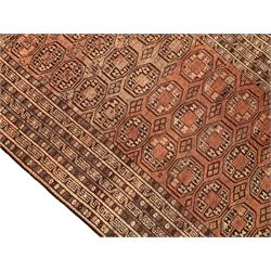 Persian Bokhara jade ground rug, the field decorated with repeating Gul motifs and lozenges, multiple band borders with repeating design (178cm x 130cm); and Bokhara red ground rug, decorated with geometric shapes and multi-band border (172cm x 118cm)