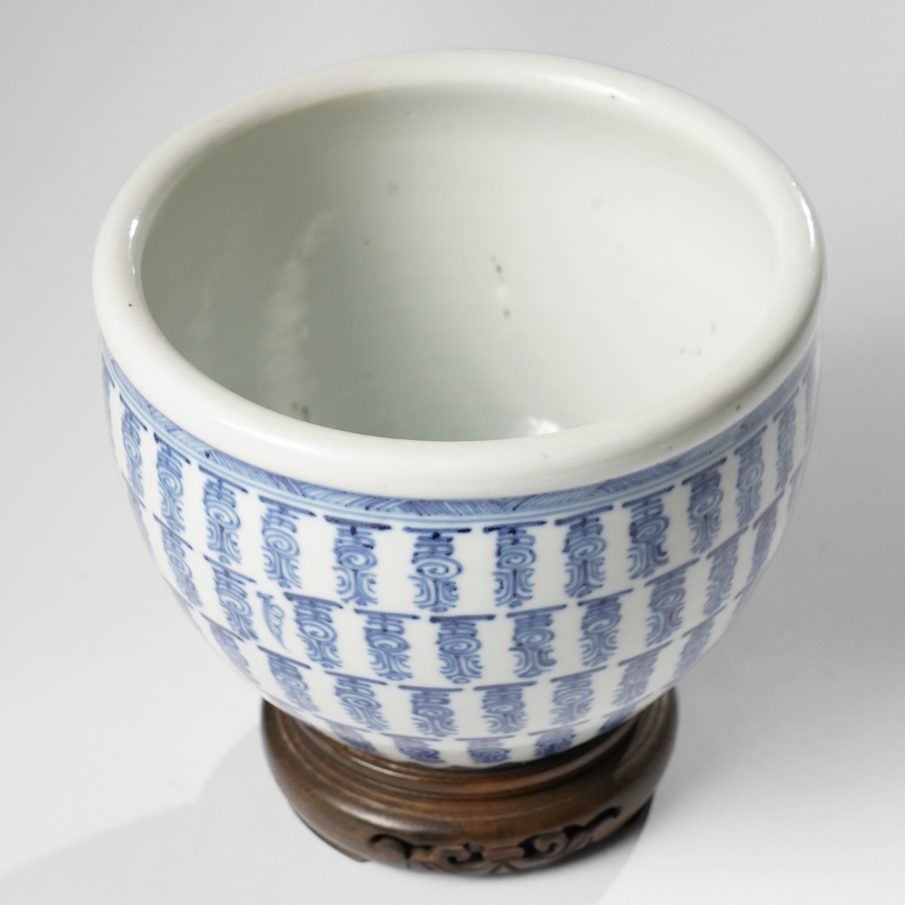 Chinese fish bowl, painted profusely with repeating symbols in blue, on hardwood stand, unmarked, including stand H16cm