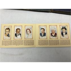 Three albums of cigarette cards including Wills Recruiting Posters, Military Motors and Allied Army Leaders, cricketers etc; another album containing a large quantity of laid-in cigarette cards; and an album of thirty-seven postcards of dogs by Mac (5)