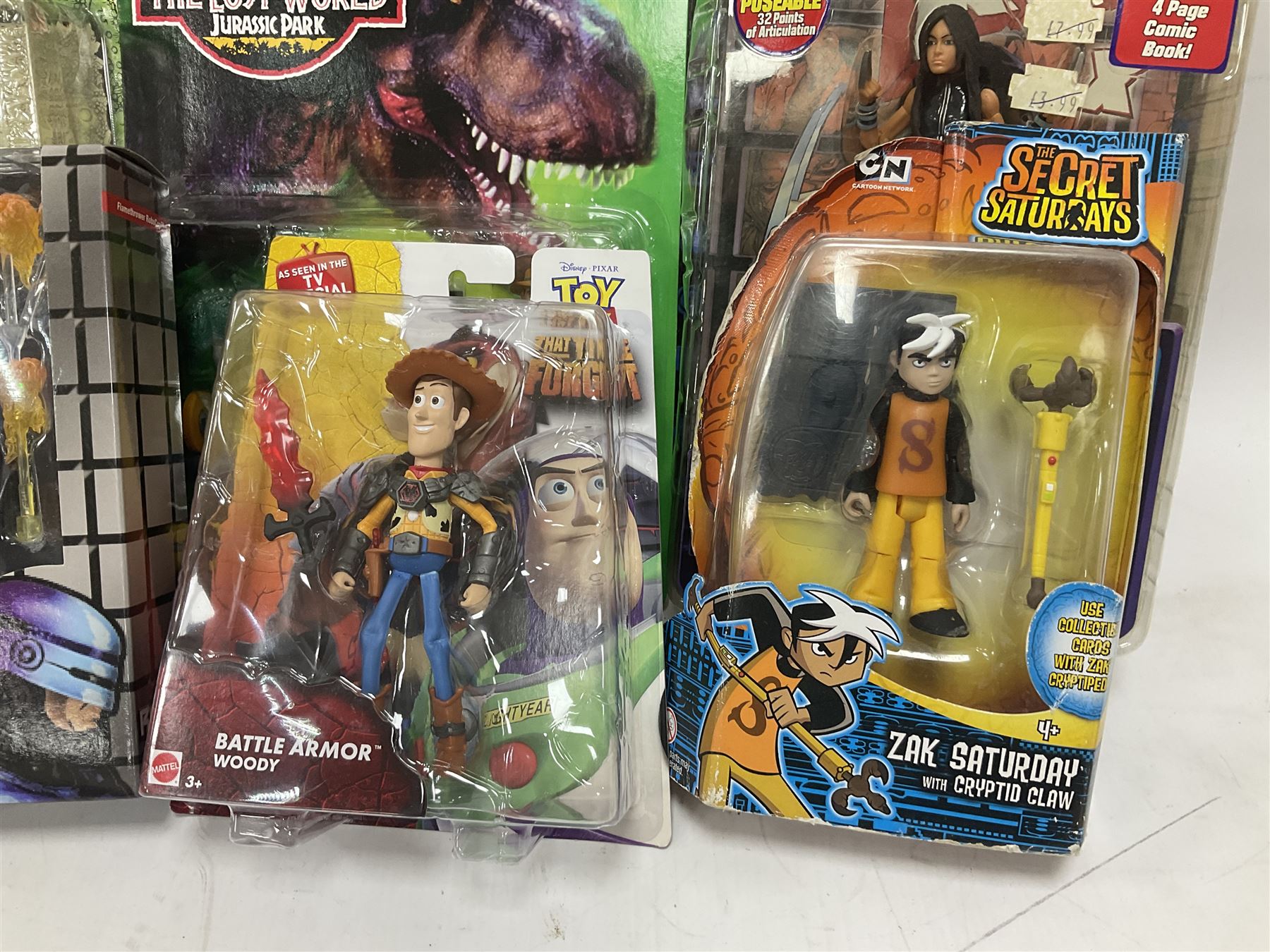 Fourteen carded action figures comprising Toy Story, X-Men Marvel Legends, Lord of the Rings, The Lost World Jurassic Park (2), The Secret Saturdays, Wallace & Gromit, Corgi Tom & Jerry (4), Flintstones, Lost in Space and Disney Infinity Cars; all in unopened blister packs; together with two boxed Robocop figures and carded James Bond car (17)