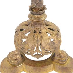 Gilt table lamp, three lion paw feet on a triangular base with column central support decorated with floral motifs, with octagonal shade, H85cm 