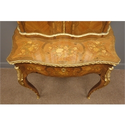  20th century French ormolu mounted marquetry, Bonheur du Jour, raised serpentine top with two doors, enclosed by figural mounts, projecting base with leather inset writing slide drawer, angular cabriole legs with floral scroll mounts, all over decorated with coloured wood panels of ribbon tied floral bouquets, W80cm, H134cm, D44cm  