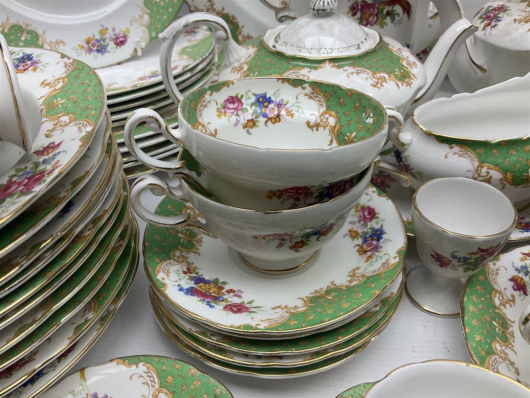 Paragon Rockingham pattern part tea and dinner service including three teapots, milk jug, cups and saucers of various sizes, ten soup bowls, ten side plates, ten dinner plates etc (96)