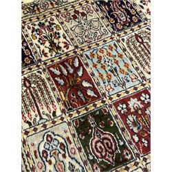 Persian Heriz design rug, ivory ground with rectangular panels each depicting garden scenes of tree of life, plants and Boteh motifs, the guarded border decorated with wildlife and bird scenes