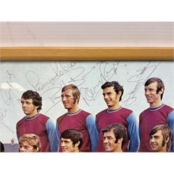 1970-1 photograph of West Ham United FC squad members, including Bobby Moore, Geoff Hurst, Harry Redknapp, Trevor Brooking, Jimmy Greaves, Billy Bonds etc, most players with signatures, 30 x 45cm, framed and glazed