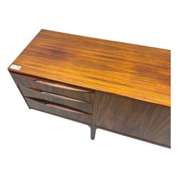 Tom Robertson for McIntosh of Kirkcaldy - mid-20th century 'Dunfermline' sideboard, the central twin cupboard doors flanked by bank of three drawers to one side and a fall front drinks cabinet to the other, raised on tapered supports