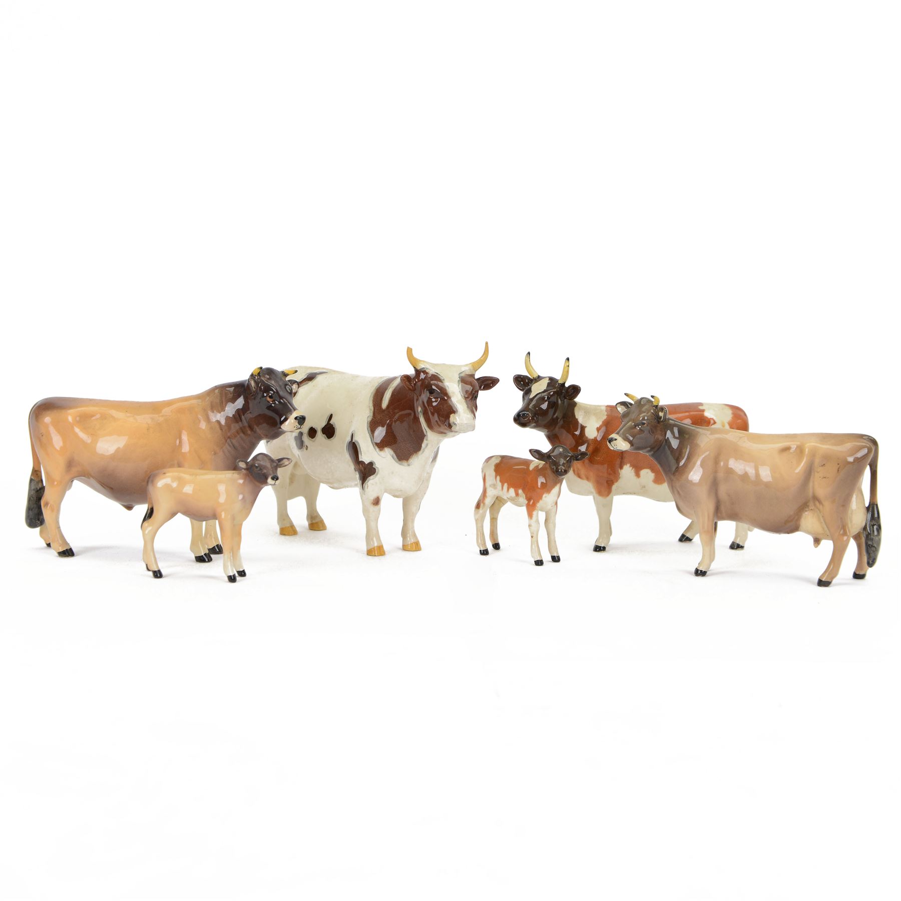 Six Beswick cattle figures, comprising Jersey family group; Bull Ch. Dunsley Coy Boy, model 1422, Cow Ch. Newton Tinkle, model 1345 and Calf, model 1249, Ayrshire family group; Bull Ch. Whitehill Mandate, model 1454, Cow Ch. Ickham Bessie, model 1350, and Calf, model 1249