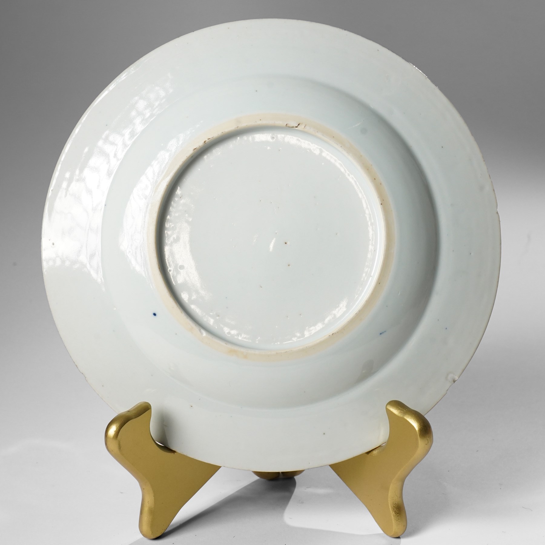 Pair of Chinese Kangxi period blue and white plates, painted in underglaze blue, decorated centrally with an unrolled handscroll revealing a shanshui landscape among foliage, D23cm (2)