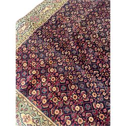 Persian Mahal rug, the blue ground field decorated with repeating Herati motifs, guarded pale ground border decorated with stylised panels