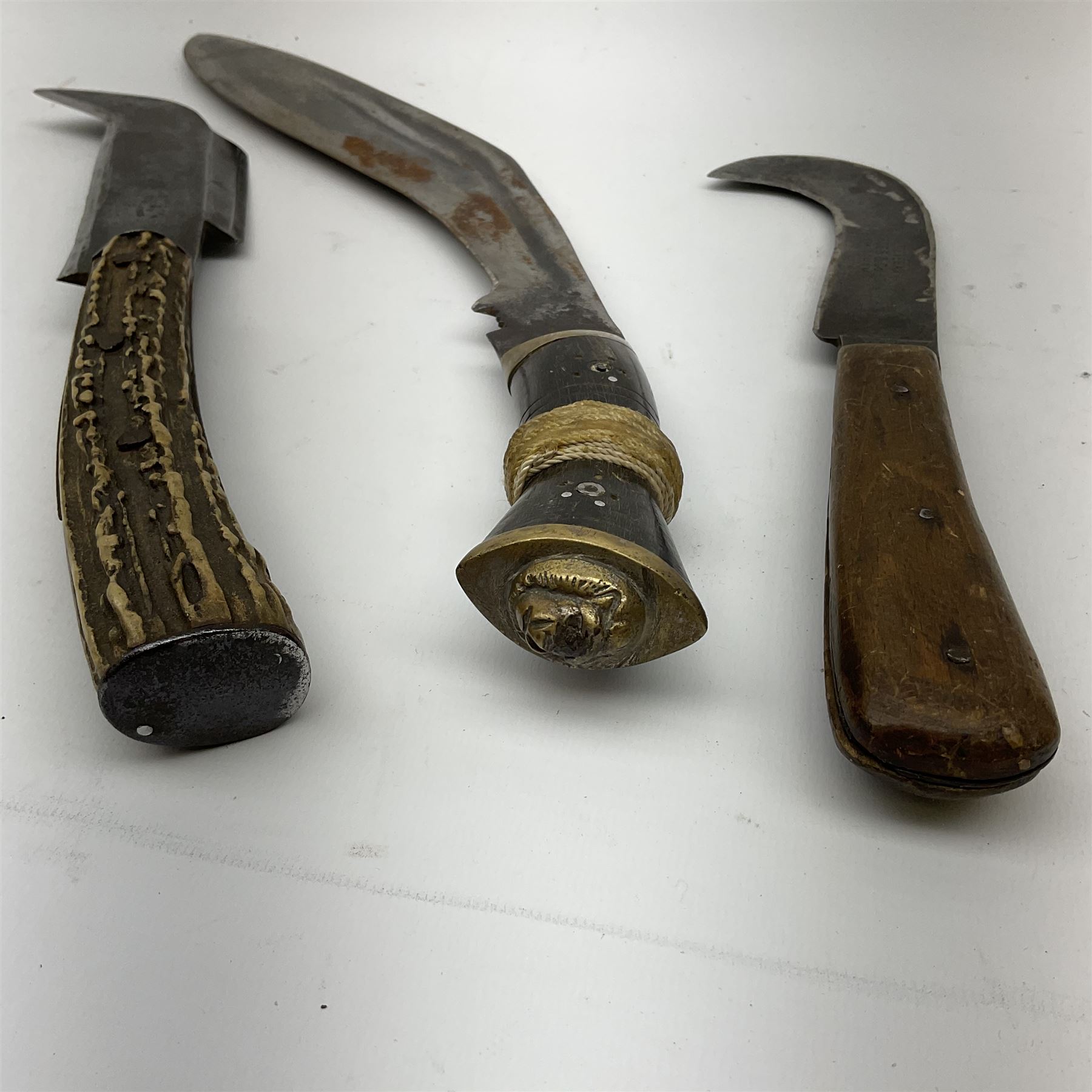 Two late 19th/early 20th century billhooks - one blade marked 'Brumby & Middleton' with Victoria cypher and antler grip L30.5cm, the other blade marked 'The Veteran Yates & Co Birmingham' with Calcutta retailer's mark to the ricasso and split wooden grip L26.5cm; together with an Indian kukri (3)